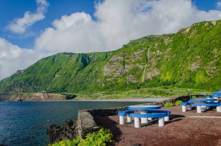 Photo for A beautiful scenery of sitting area by Poco do Bacalhau Waterfall and river in Flores Island, Azores, Portugal - Royalty Free Image