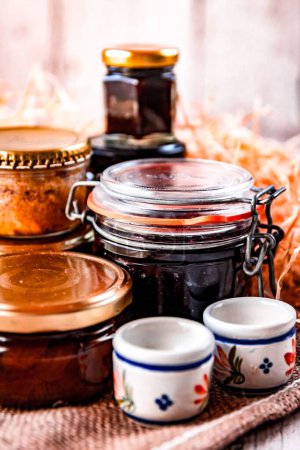 Photo for A vertical shot of jars filled with various jams - Royalty Free Image