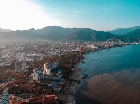 Photo for An aerial shot of Puerto Vallarta with a view of the city ocean mountains in the back during the sunrise - Royalty Free Image