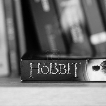 Photo for A vertical grayscale closeup of J. R. R. Tolkien's The Hobbit novel on a shelf. - Royalty Free Image