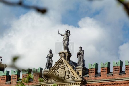 Téléchargez les photos : Un gros plan à angle bas de statues de toit de la cathédrale gothique construite en brique de Saint Canute - en image libre de droit