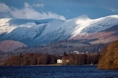 Téléchargez les photos : Un paysage à couper le souffle du Lake District avec de hautes montagnes enneigées sous le ciel nuageux - en image libre de droit