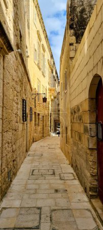 Téléchargez les photos : Vue verticale d'une étroite passerelle entre des bâtiments à Mdina, Malte - en image libre de droit