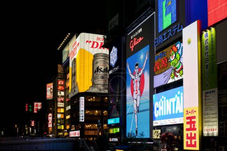 Photo for A beautiful view of Tokyo, Japan at night with luminous advertising signs on buildings illuminating the dark - Royalty Free Image