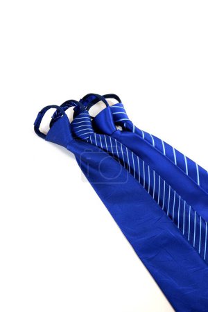 Photo for A vertical shot of a group of blue polyester neckties isolated on a white background. - Royalty Free Image