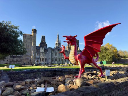 Photo for A red dragon in front of the Cardiff Castle and Victorian Gothic revival mansion in Cardiff, Wales. - Royalty Free Image