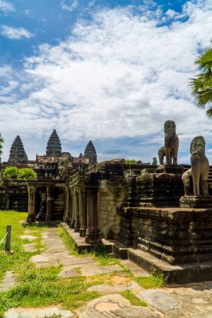 Photo for A vertical view of sculptures with the temple towers of the largest religious temple complex Angkor Wat of Cambodia - Royalty Free Image