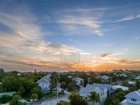 An aerial of a neighborhood along Holmes beach at Anna Maria Island, Florida on a summer evening during sunset