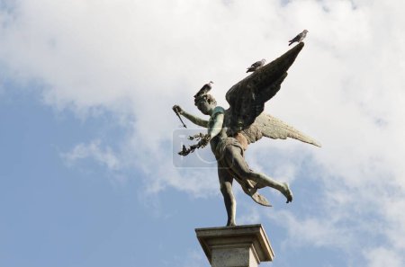 Photo for A low angle shot of beautiful statue of the Greek god Anteros under blue sky - Royalty Free Image
