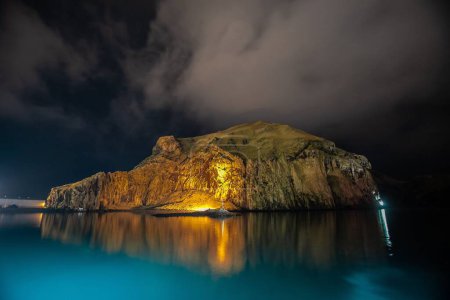 Photo for Spectacular view of waterside rock in the bright light at night. Exploring Icelandic mountains and landscapes - Royalty Free Image