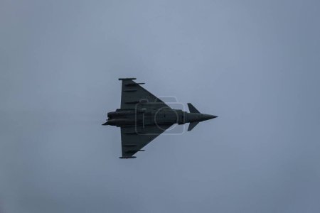Photo for A closeup shot of a fighter jet flying against the background of gloomy clouds - Royalty Free Image