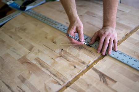 Photo for A carpenter putting a line mark on a wooden surface - Royalty Free Image