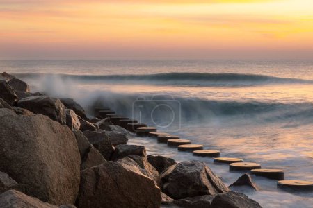 Photo for A long exposure of waves at Fort Fisher State Park at a pink and scenic sunset - Royalty Free Image