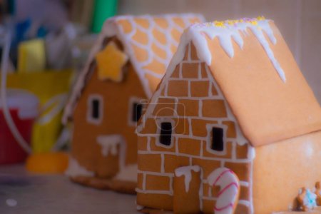 Photo for A closeup of gingerbread houses with frosting for Christmas on the table - Royalty Free Image