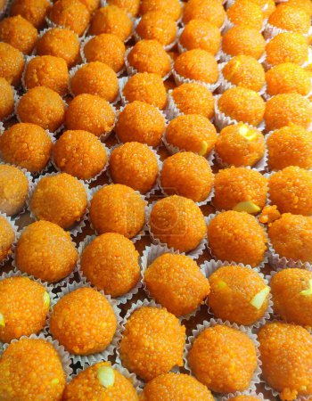 Photo for Motichur Laddu is a very popular round shaped Indian sweet made with chickpea peals called boondi and saffron and cardamom flavored sugar syrup. - Royalty Free Image