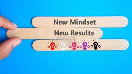 Photo for A new mindest, new results quote on wooden sticks with blue background. Energy concept - Royalty Free Image