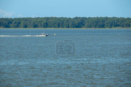 Photo for The York River on a sunny day and the dense forest on the horizon in Gloucester, Virginia US - Royalty Free Image