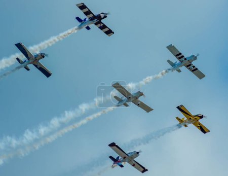 Photo for The aircrafts in a formation flight in the blue sky at an airshow - Royalty Free Image