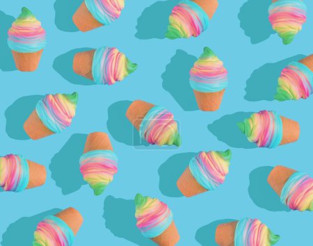 Foto de Un patrón de helado colorido representado en 3D sobre un fondo azul brillante - Imagen libre de derechos