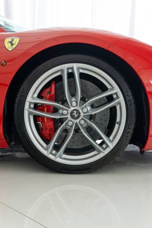 Photo for A vertical shot of a Ferrari 488 GTB Rosso Corsa with a silver wheel with carbon hub cap - Royalty Free Image