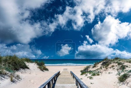 Photo for The cloudy blue sky over the sea captured from the beach del Palmar in Cadiz, Andalusia - Royalty Free Image