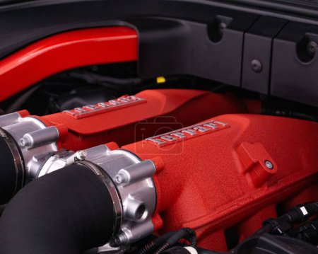 Photo for A closeup of Ferrari Portofino engine bay, red engine cover with Ferrari inscription. - Royalty Free Image