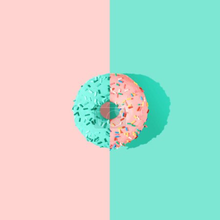Foto de Un donut de color rosa y azul vidriado en 3D sobre el fondo azul brillante - Imagen libre de derechos