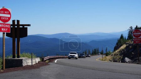 Photo for A scenic view of cars driving on an asphalt road with mountains in the background near Mount Hood - Royalty Free Image