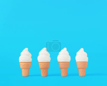 Foto de El 3D renderizado conos de helado blanco sobre el fondo azul brillante con espacio de copia - Imagen libre de derechos