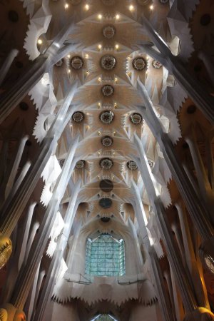 Foto de El hermoso interior de la famosa iglesia de la Sagrada Familia en Barcelona con columnas curvas - Imagen libre de derechos