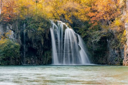 Photo for A long exposure of a waterfall flowing down into a lake in Plitvice Lakes national park - Royalty Free Image