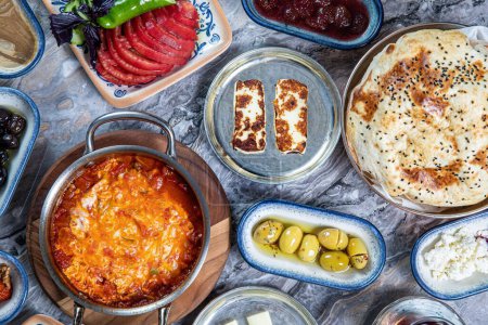 Photo for A top view of gourmet middle eastern lunch and breakfast food with olives on a granite table - Royalty Free Image