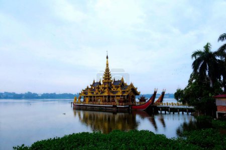 Photo for A traditional Asian architecture palace on a floating ship at the shore of Kandawgyi Lake - Royalty Free Image