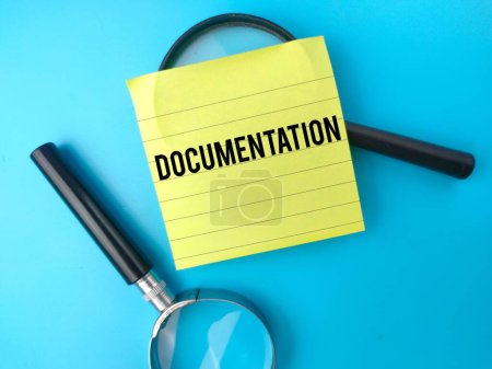 Photo for Top view magnifying glass and sticky note with the word DOCUMENTATION. Business concept. - Royalty Free Image