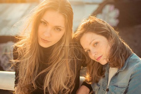 Photo for Two Hispanic girls dressed in casual clothes, posing outdoors on a sunny day, the concept of beauty - Royalty Free Image