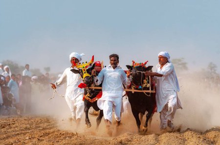 Téléchargez les photos : Le peuple du village du Pendjab vêtu de blanc lors de la course Bull Karah - événement rural au Pakistan - en image libre de droit
