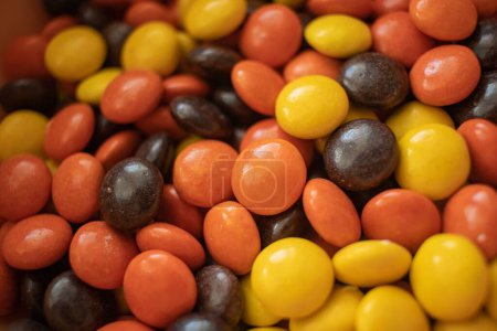 Photo for The autumn-colored Reese Pieces candies randomly filled on each other without packets - Royalty Free Image