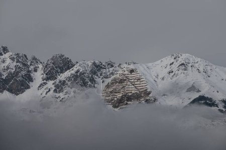 Photo for Snowy mountains of the Nordkette in Tyrol in the fog are a fantastic experience for all holidaymakers and locals - Royalty Free Image