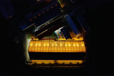 Photo for An aerial view of  an illuminated cowshed at night - Royalty Free Image