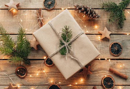 Photo for Top view photo of christmas present, decorations and lights on wooden boards - Royalty Free Image