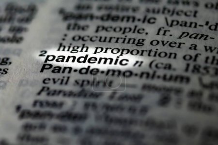 Photo for A closeup of a word pandemic highlighted in dictionary - Royalty Free Image