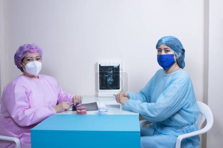 Photo for The dentist and patient performing an x-ray with all sanitary measures - Royalty Free Image