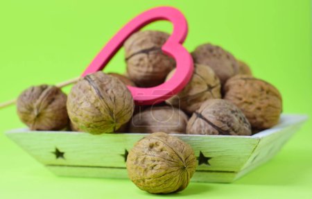 Photo for A closeup shot of very healthy walnut on a green table - Royalty Free Image
