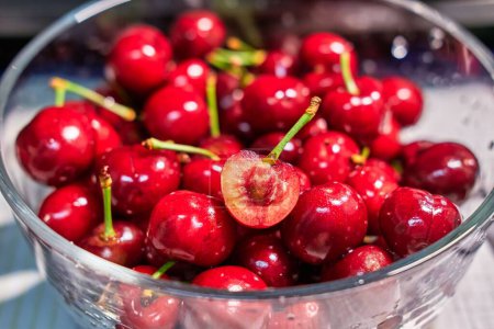 Photo for A closeup of bowl of wet red plump juicy cherries - Royalty Free Image
