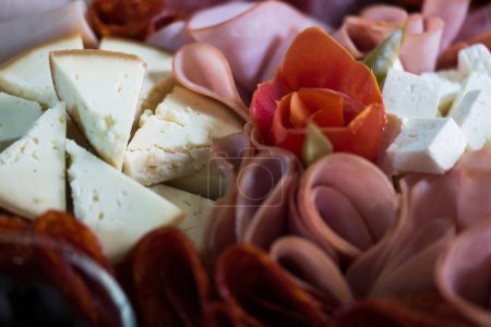 Photo for A closeup shot of a table with mix of meats and cheese - Royalty Free Image