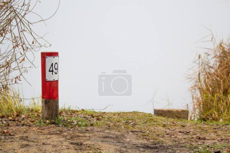 Photo for A wooden fishing pole with a plate and the number - Royalty Free Image