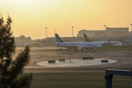 Photo for The view of airplanes parked in the Humberto Delgado Airport at sunset - Royalty Free Image