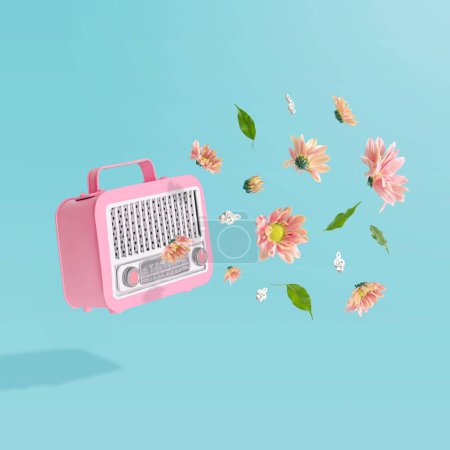Téléchargez les photos : Une 3D d'un récepteur de radio vintage rose avec des fleurs d'été colorées sur un fond bleu pastel - en image libre de droit