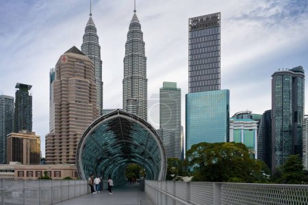 Photo for The pedestrian bridge Pintasan Saloma with Petronas Towers in background, Kuala Lumpur, Malaysia - Royalty Free Image