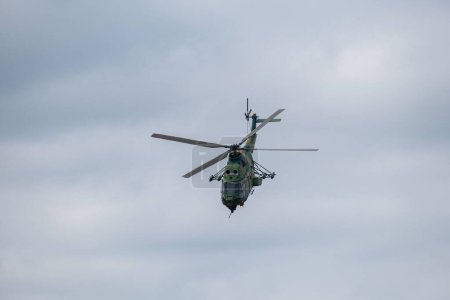 Photo for A helicopter flying in sky - Royalty Free Image